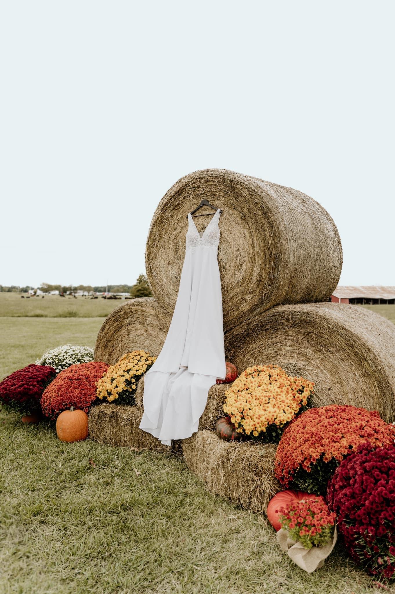 Wedding dress on hay bales